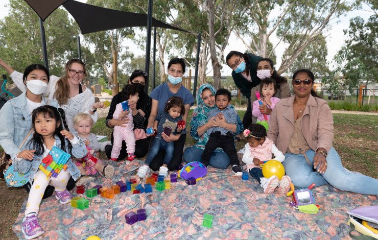 A group of children and mothers enjoying playgroup 