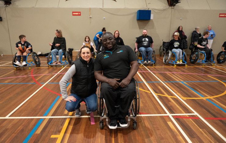 People on a basketball court in wheelchairs