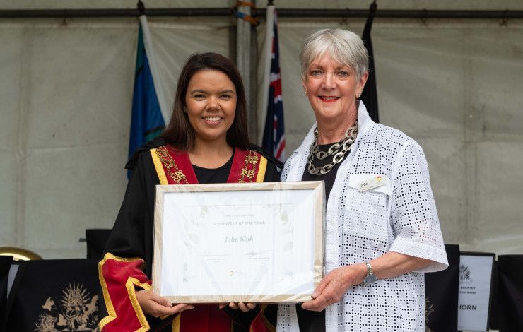 Mayor Eden Foster and Volunteer of the Year Julie Klok hold a framed certificate