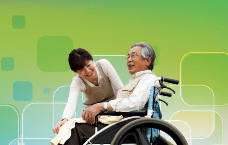 blue and green pattern background with person assisting man in wheelchair