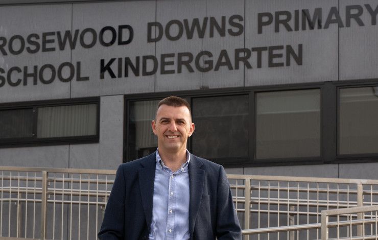 Councillor Bob Milkovic standing in front of the Rosewood Downs Primary School Kindergarten
