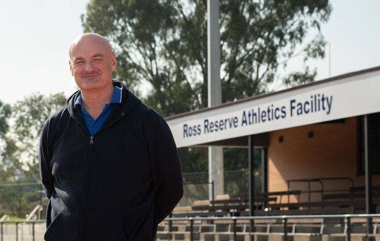 Councillor Sean O'Reilly standing in front of the Ross Reserve Athletics track
