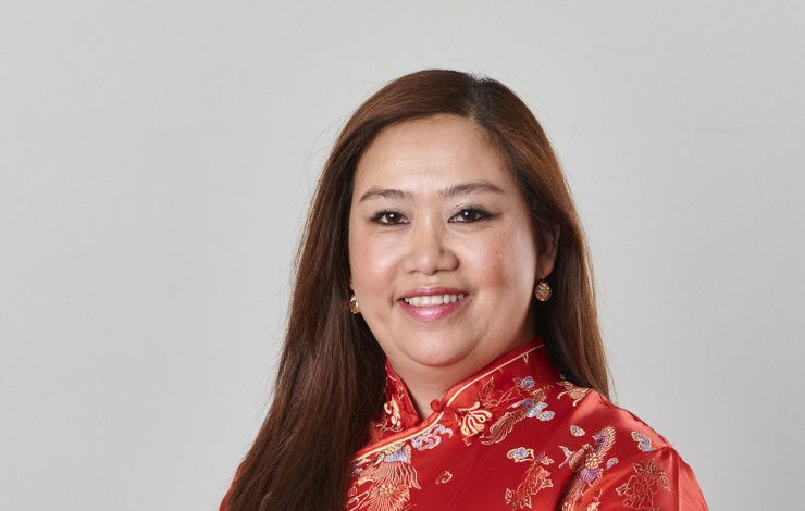 Councillor Sophie Tan in a red silk dress smiling at the camera