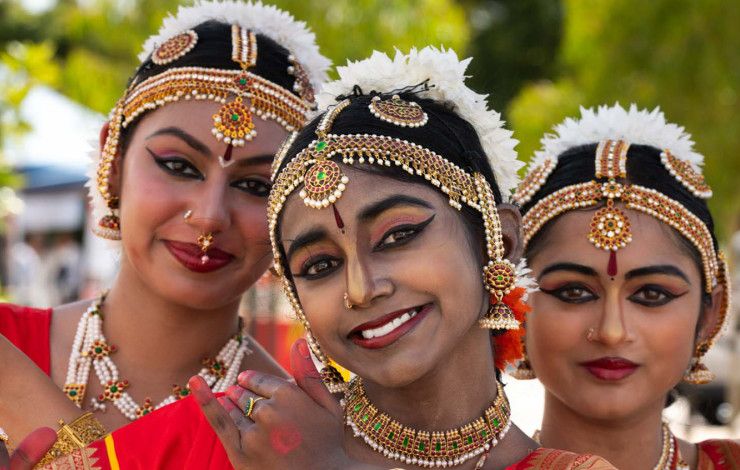 Three women dressed in cultural clothing