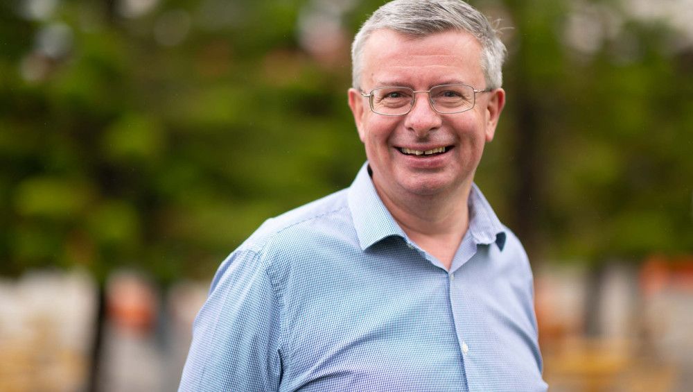 Matthew Kirwan - portrait of a man with short hair and a blue checked shirt