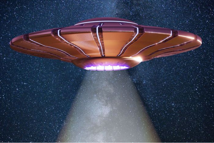 A flying saucer with a beam of light coming out of it.