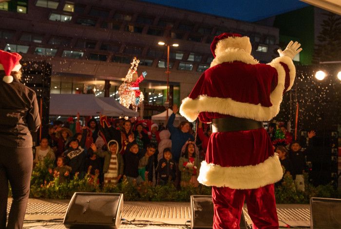 Santa and audience singing together in Harmony Square