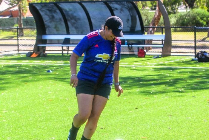 Woman kicking a soccer ball