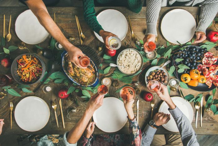 People hold their classes together on a rustic dinner table.