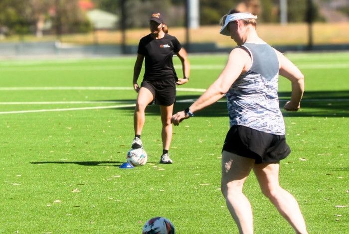 Two women playing soccer