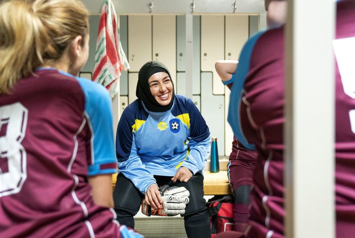 Women in hijab talking to others in change room