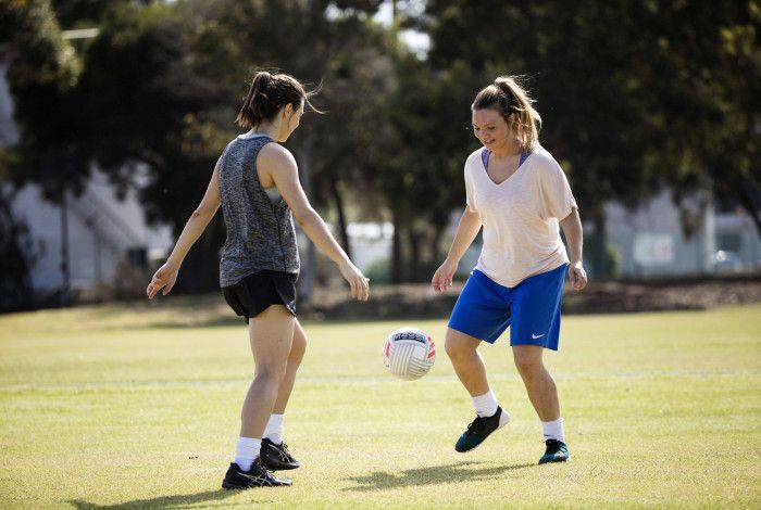 Two women playing soccer