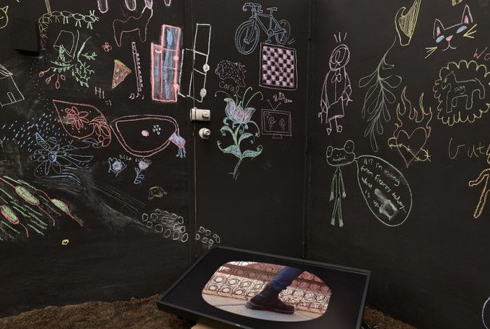 Chalk drawings on a black wall