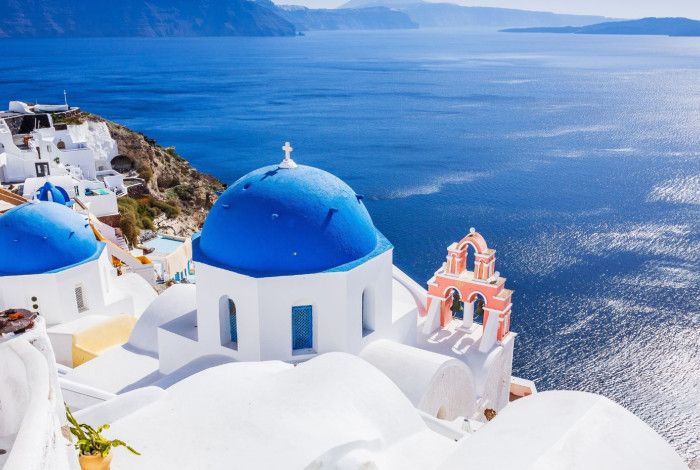 White-washed walls with blue roofed houses overlook the Mediterranean