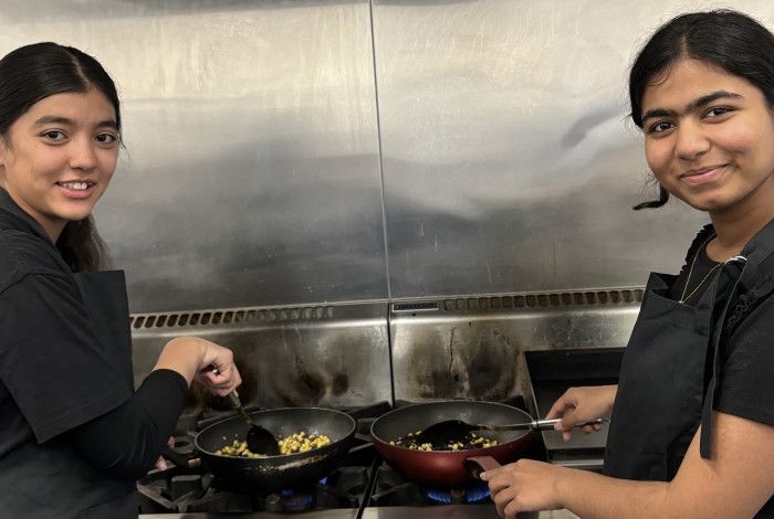 two young people cooking