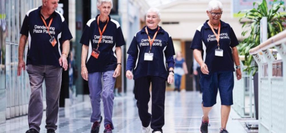 a group of people walking in a shopping mall