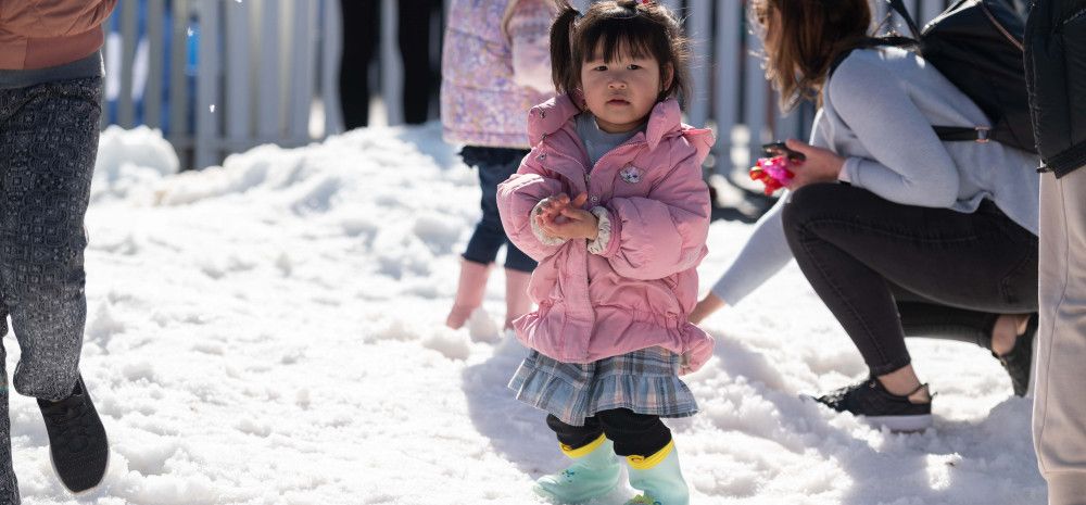 child enjoying snow play area