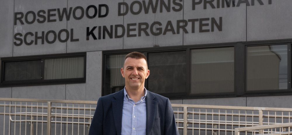 Councillor Bob Milkovic standing in front of the Rosewood Downs Primary School Kindergarten