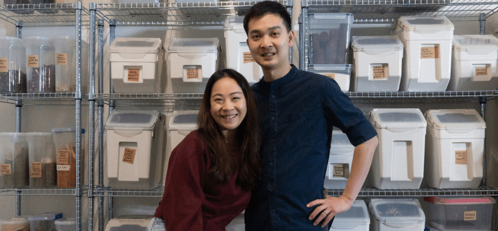 Naked Asian Grocer owners in front of bulk foods