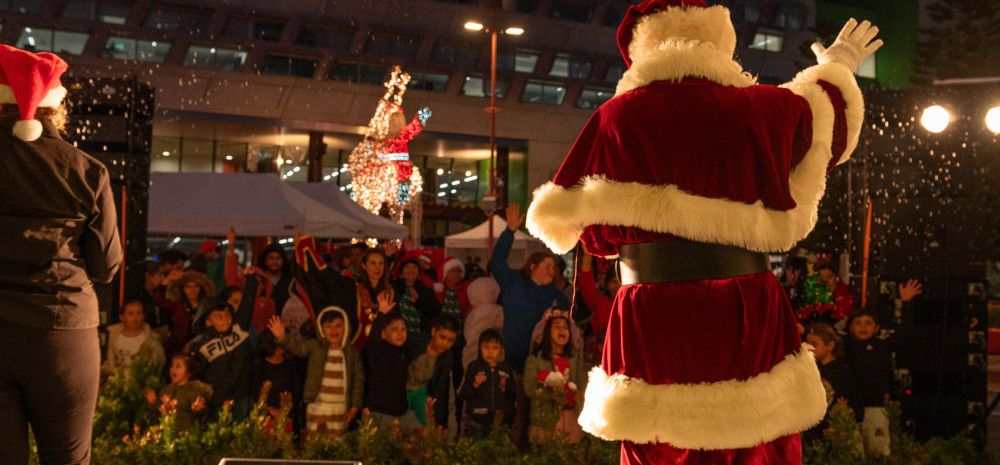 Santa and audience singing together in Harmony Square