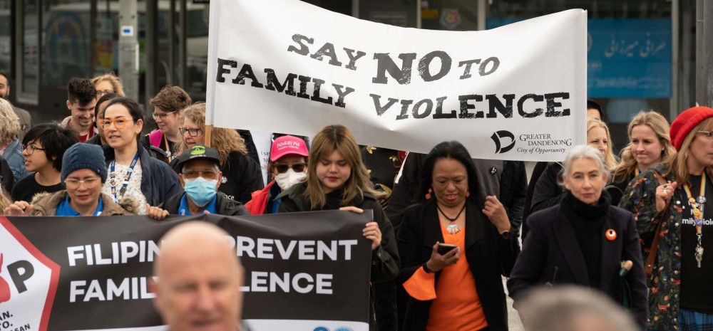 people marching together with a banner