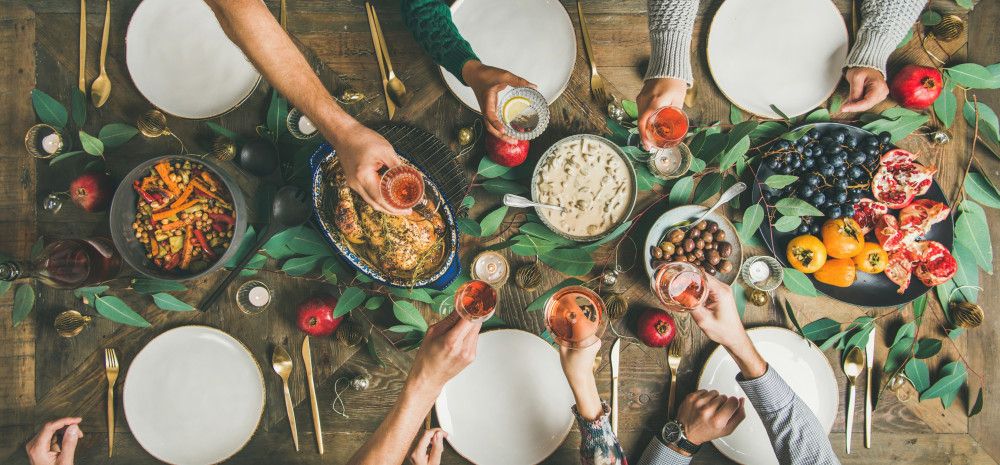 People hold their classes together on a rustic dinner table.