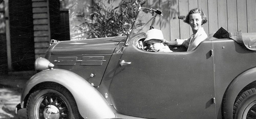 Black and White image of a car with a woman and boy sitting inside