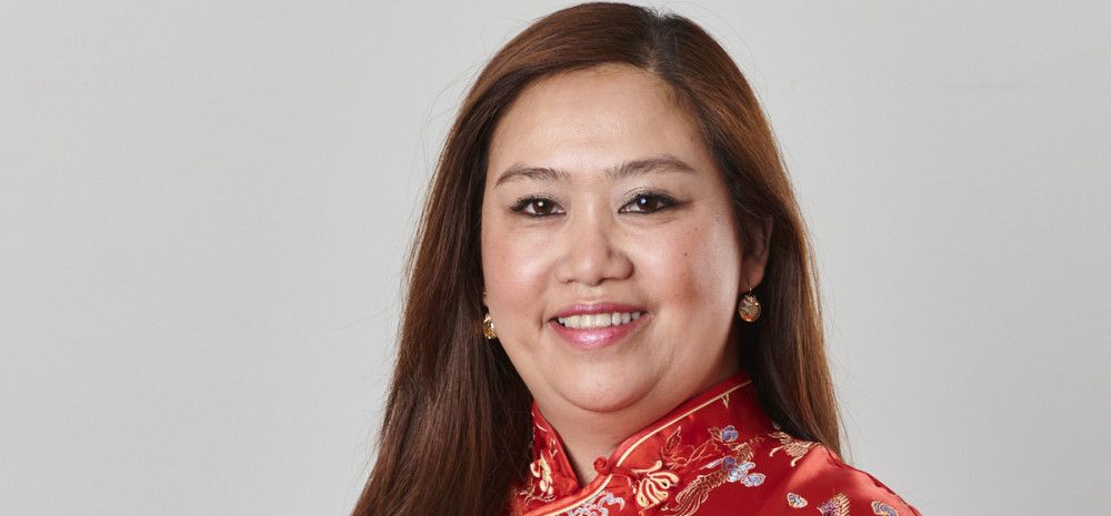 Councillor Sophie Tan in a red silk dress smiling at the camera