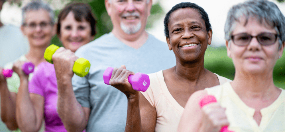 Older people using hand weights.