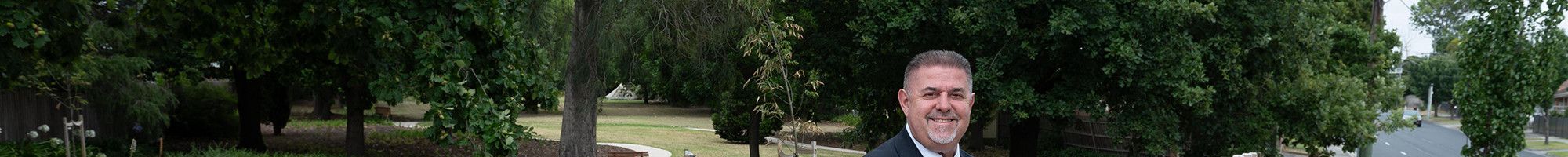 Cr Jim Memeti standing at a park