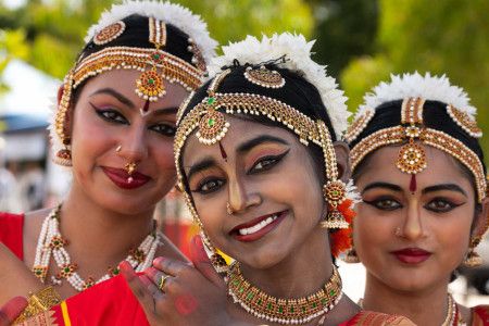 Three women dressed in cultural clothing