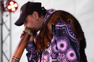 A man playing a didgeridoo