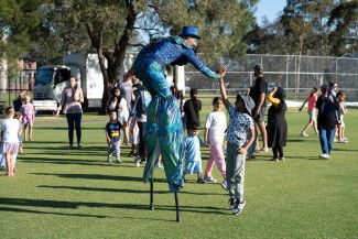 A performer engaging with children