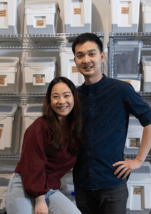 Naked Asian Grocer owners in front of bulk foods