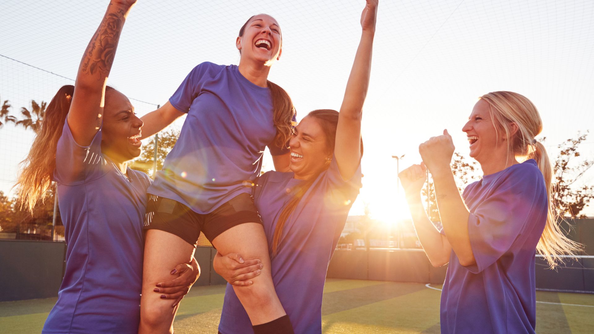 Group of girls celebrating in soccer uniforms